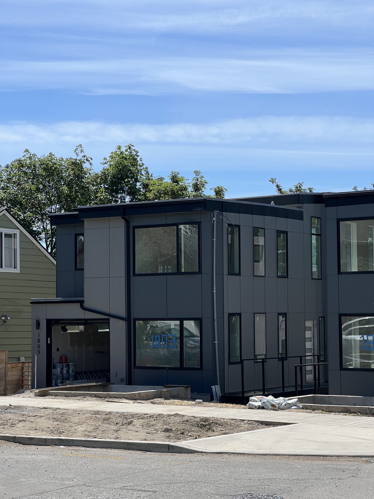 Modern charcoal James Hardie panel townhome with metal trim near Cherry Street, Seattle
